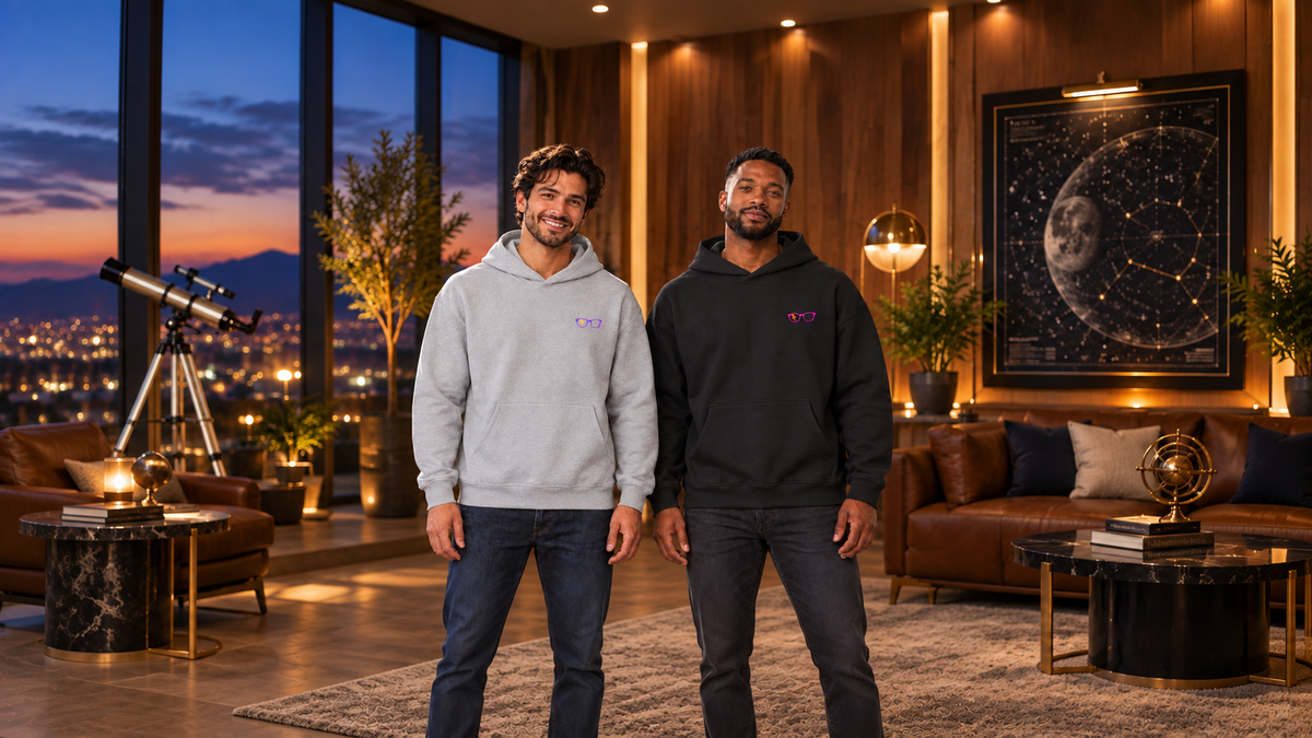 Two men wearing Clan of Nerds hoodies in an observatory